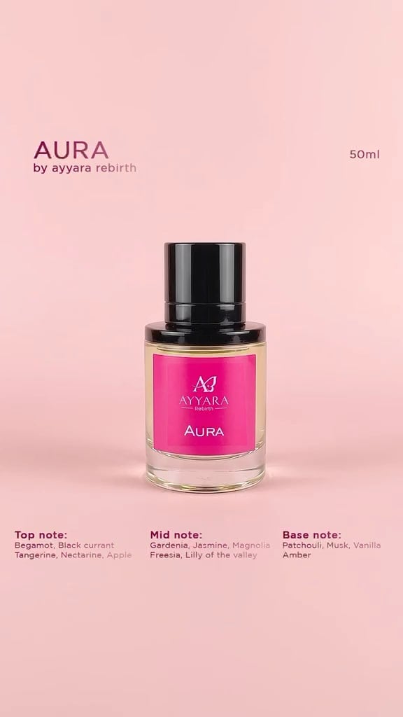A bottle of AURA by Ayyara Rebirth, 50 ml, with a pink label, against a soft pink background